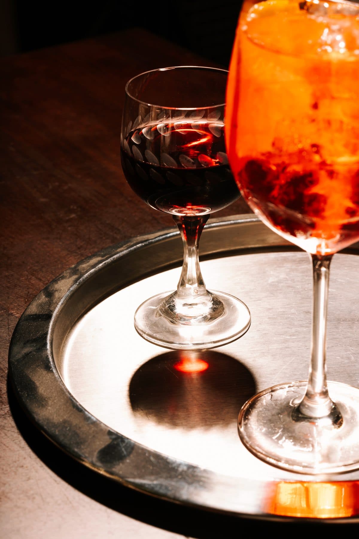 Aperol spritz and wine on a tray — aperitivo at PIENO