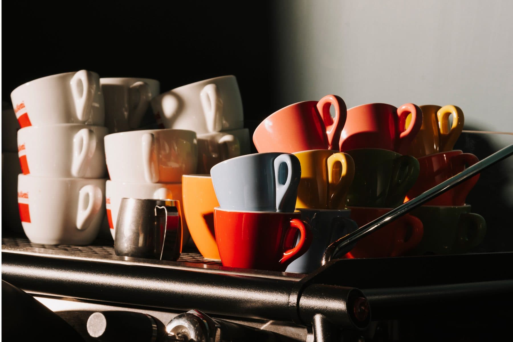 Colourful espresso cups on the machine at PIENO
